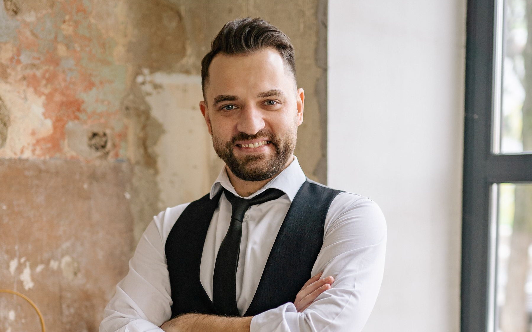 Small-business owner standing confidently in their own shop