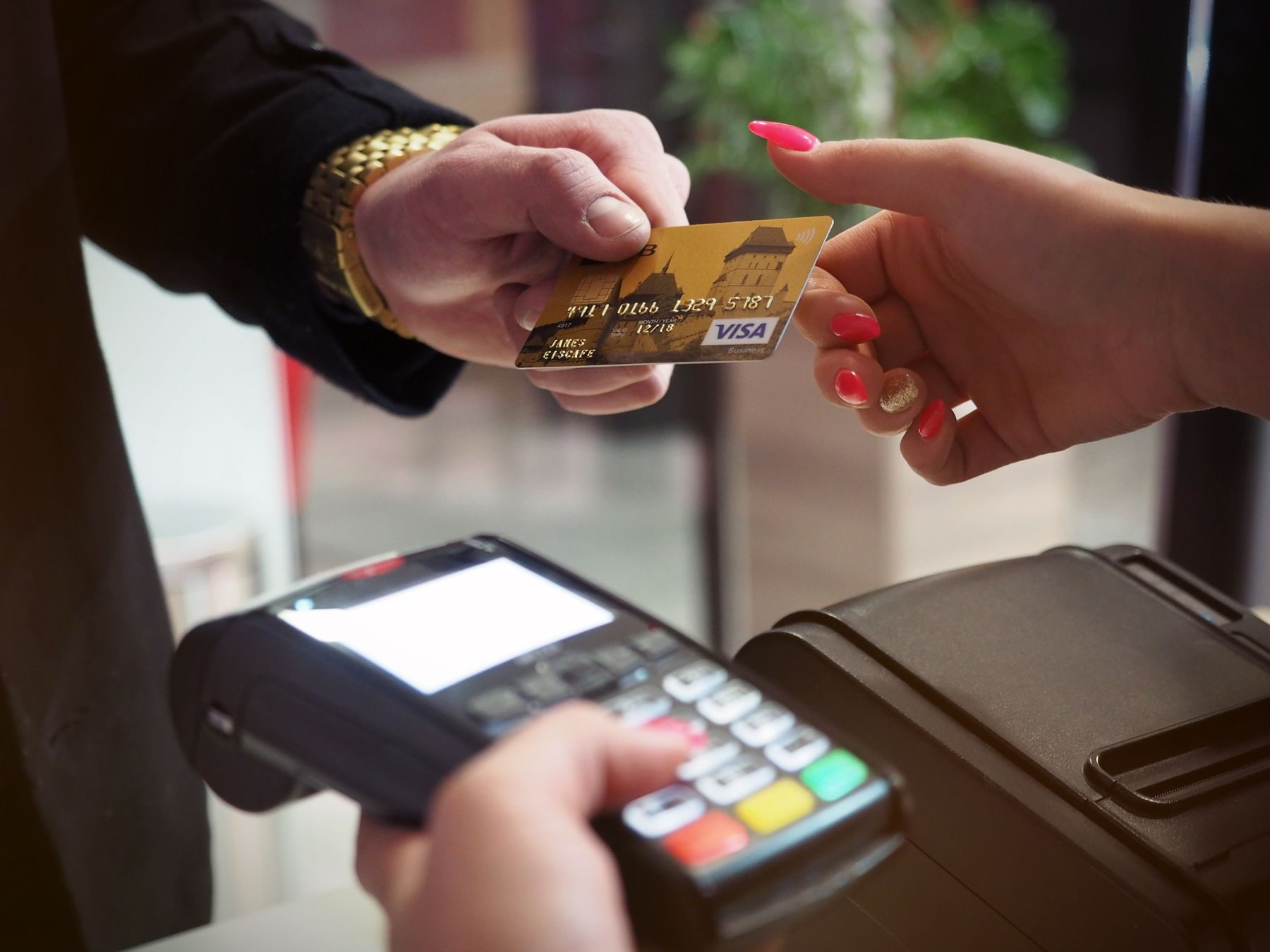 Counter staff ringing up a lunchtime queue at a card terminal