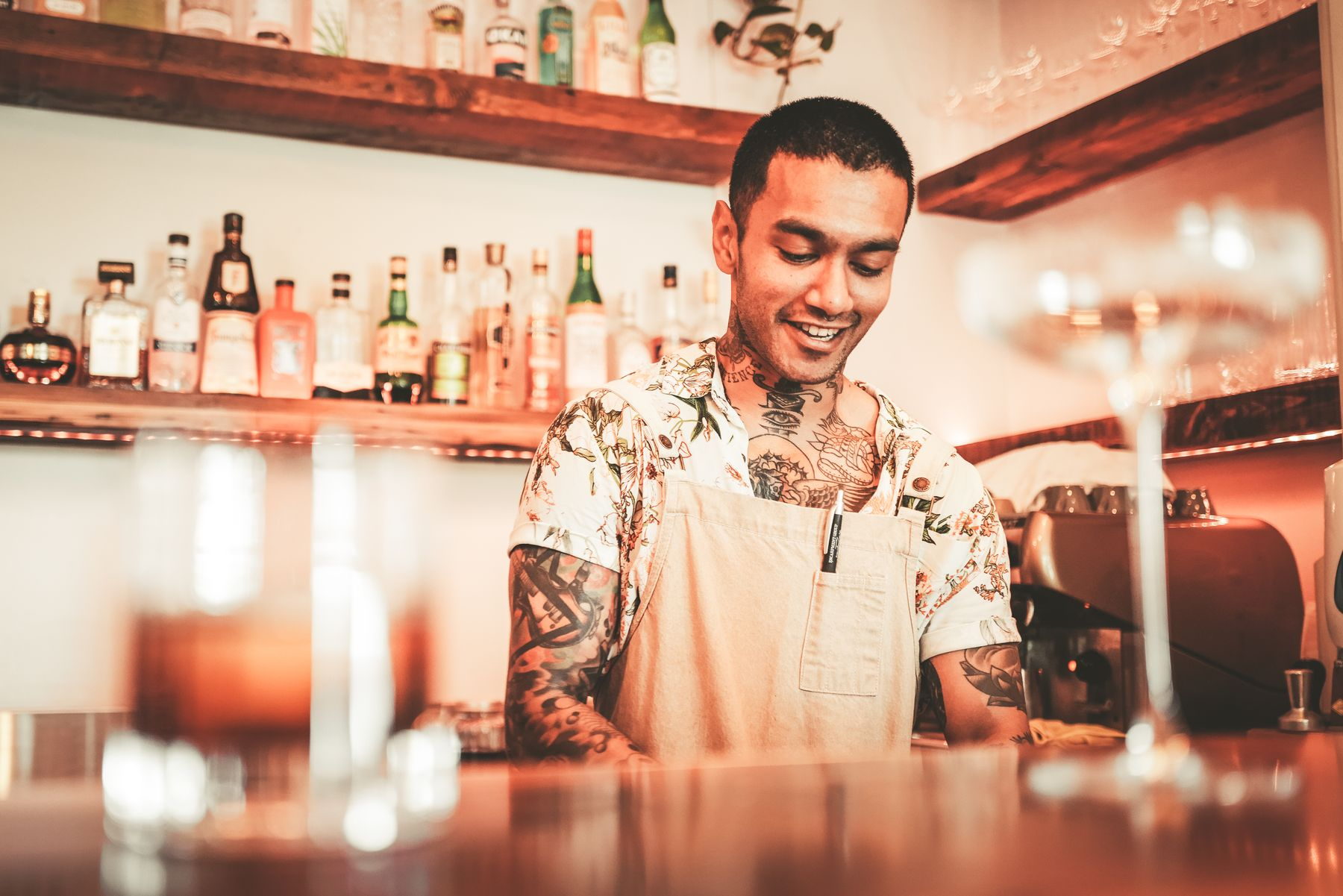 Two small-business owners standing together behind their counter